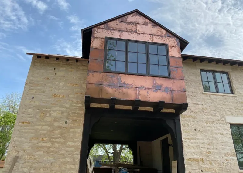 Copper metal panel facade on a stone building for Skylight Installation in Lyman
