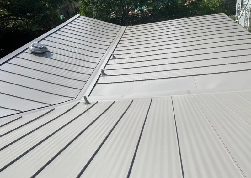 Solar attic fan installed on a metal roof for Roof Ventilation in Lyman